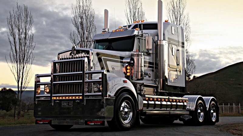 silver semi-truck on rural road