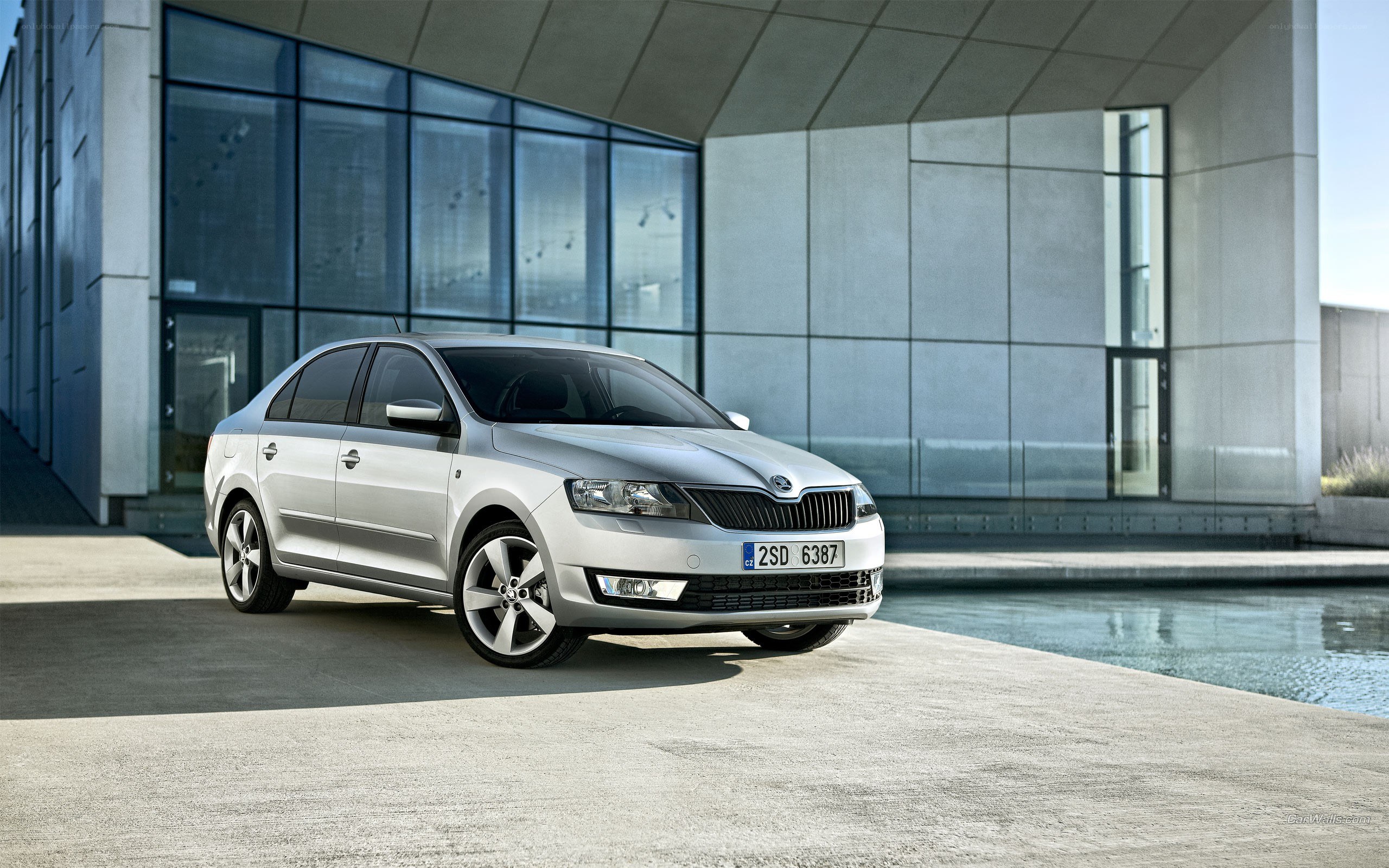 Silver Skoda sedan in modern setting