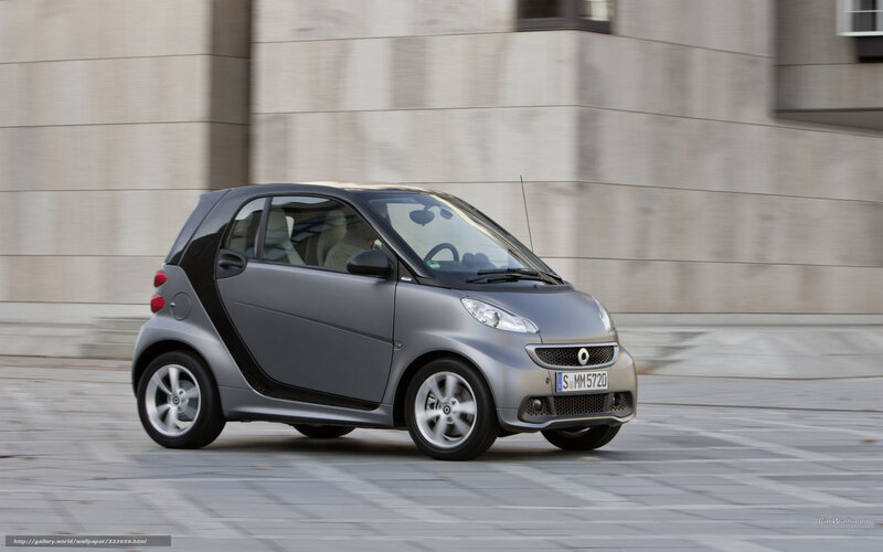 silver smart car in motion