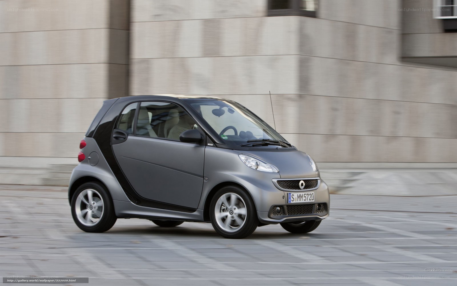 silver smart car in motion