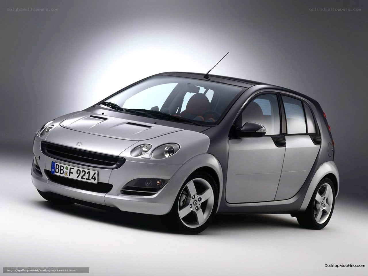 silver smart car in studio