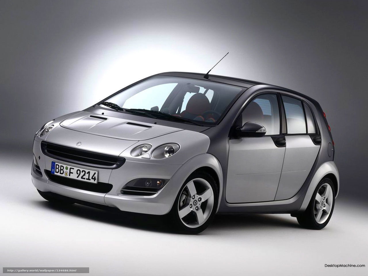 silver smart car in studio