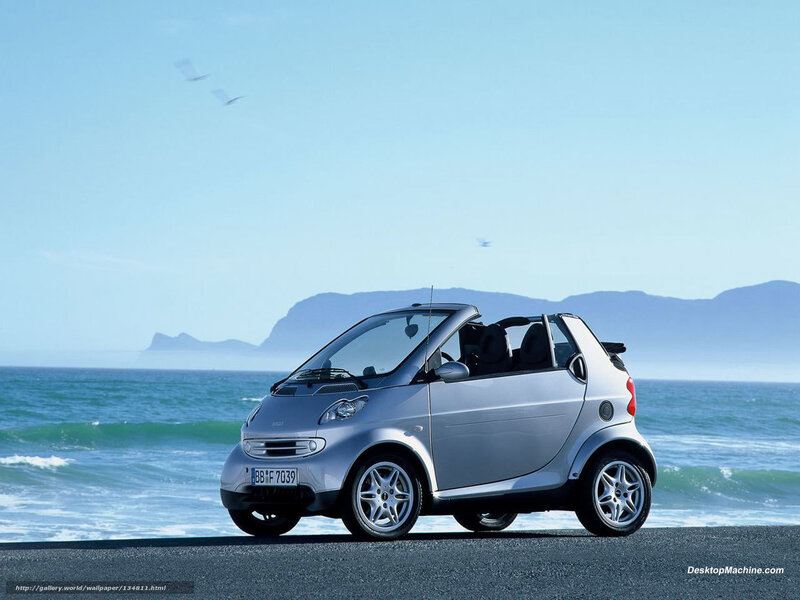 Silver smart car on beach