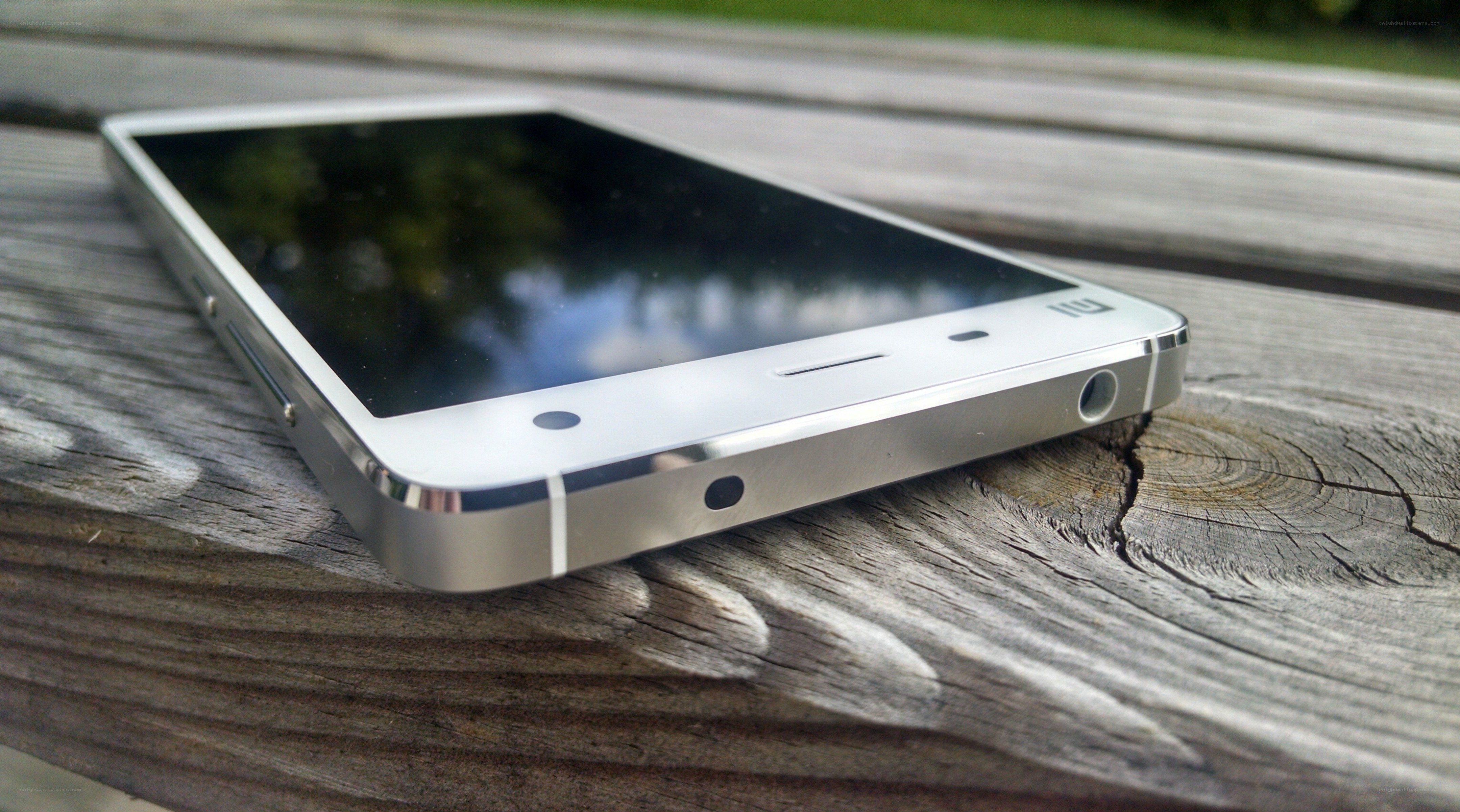 silver smartphone on wooden surface