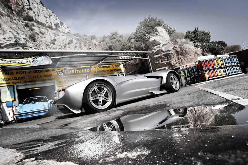 Silver sports car at a garage
