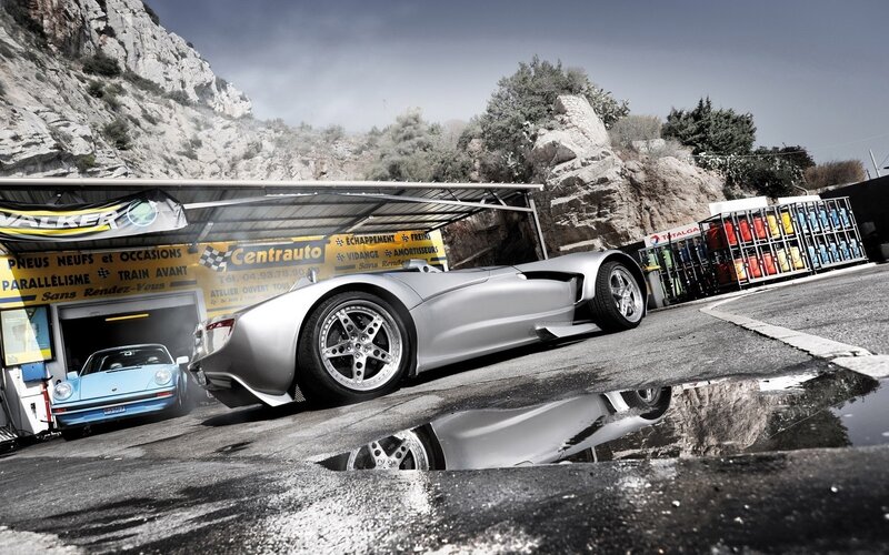 Silver sports car at a garage