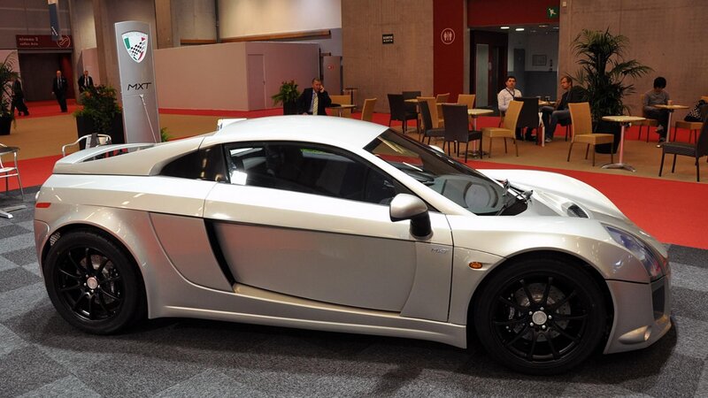 silver sports car at auto show