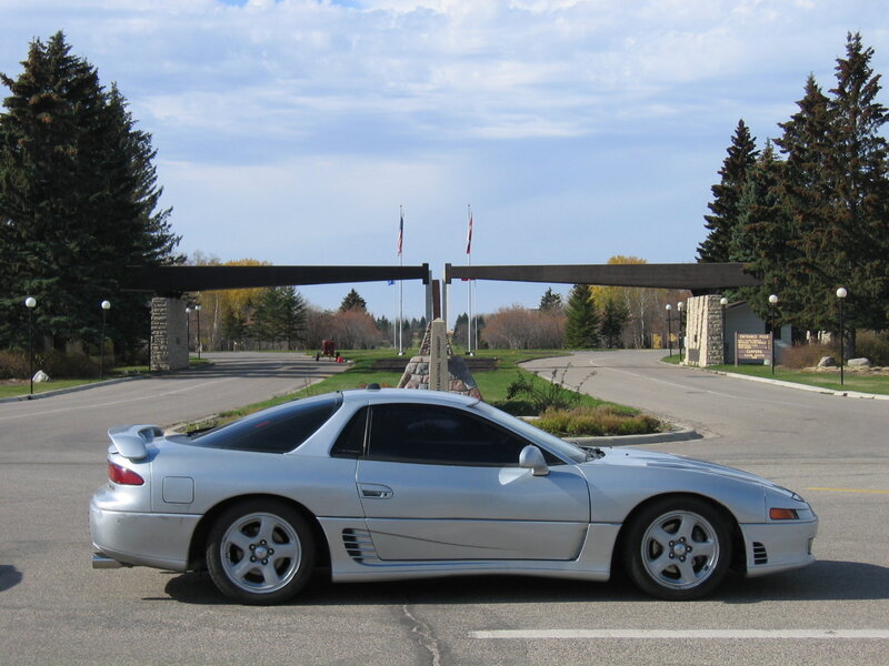 Silver sports car at border crossing