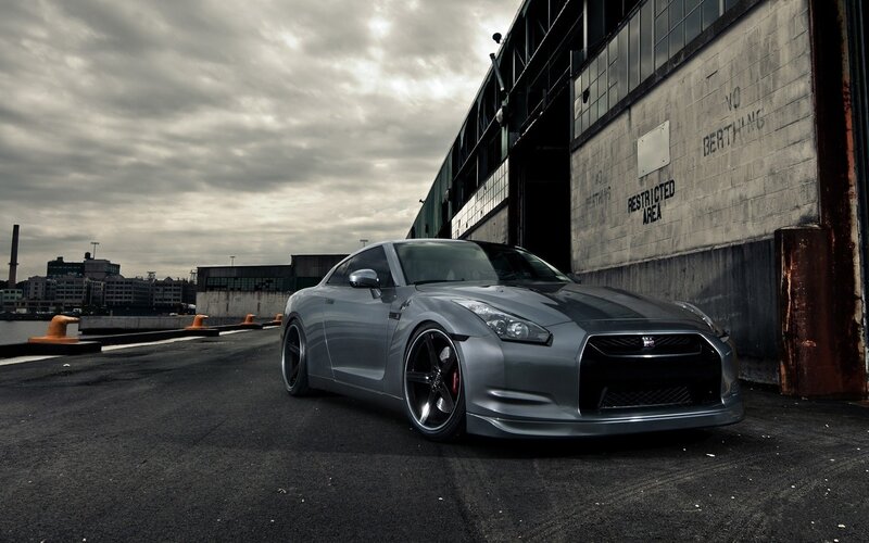 silver sports car at industrial dock