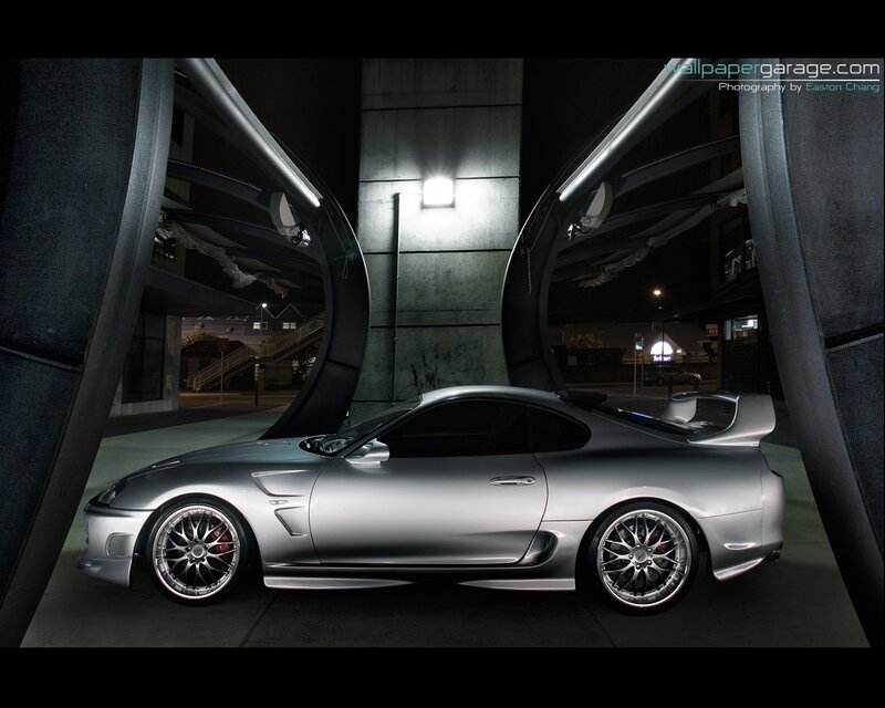 Silver sports car at night
