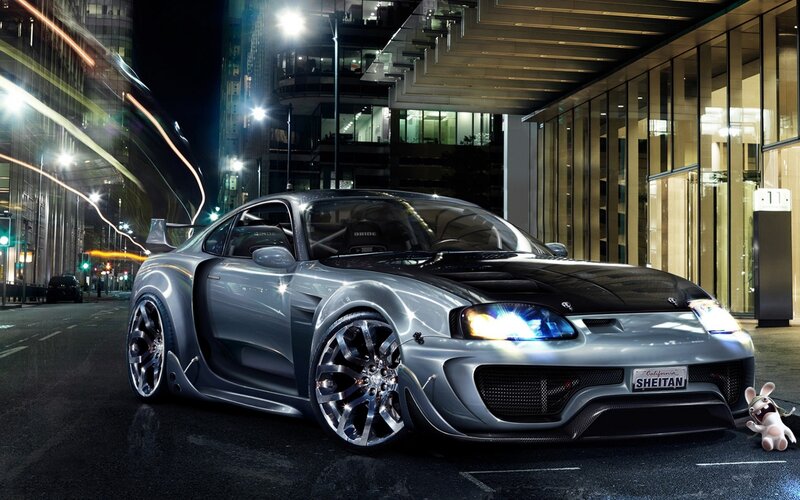 Silver sports car at night
