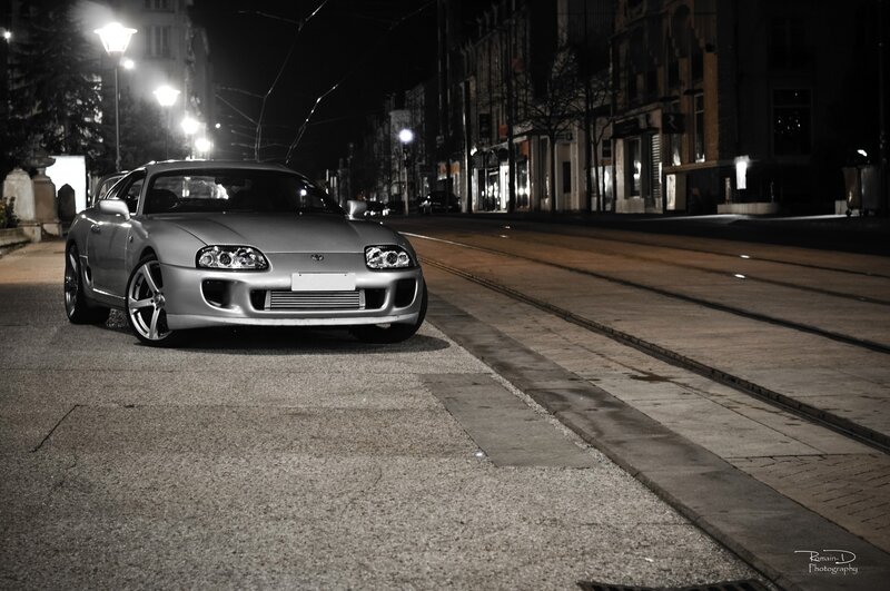 Silver sports car at night