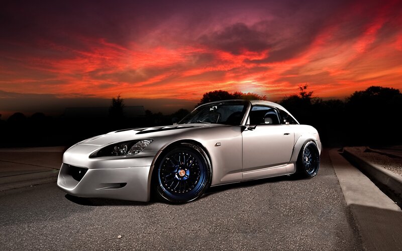 silver sports car at sunset