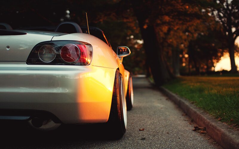 silver sports car at sunset