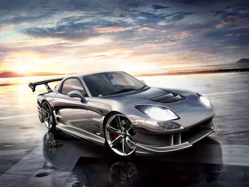Silver sports car at sunset