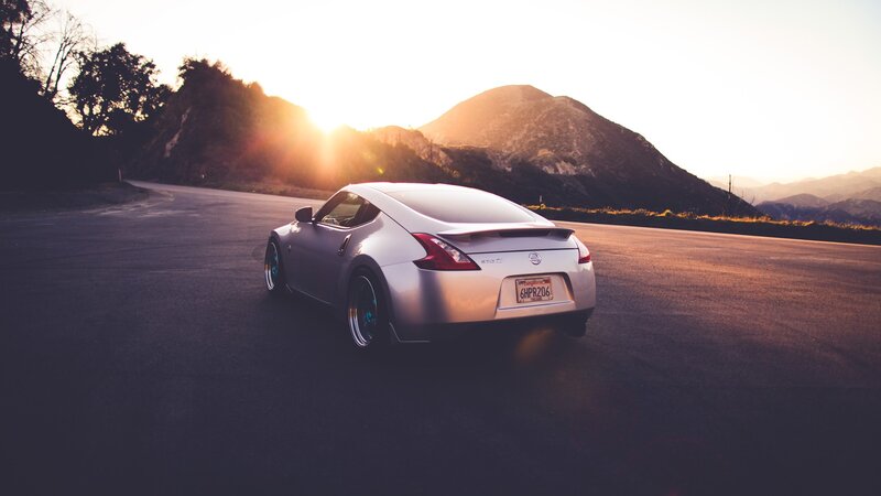 silver sports car at sunset