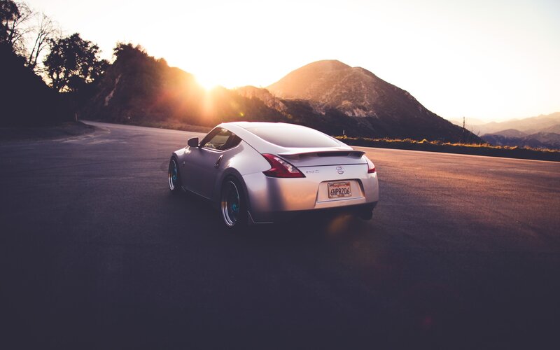 silver sports car at sunset