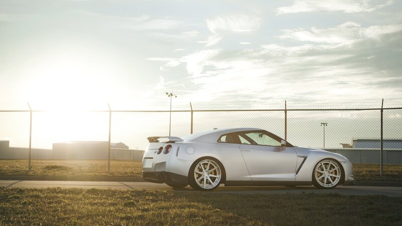 silver sports car at sunset