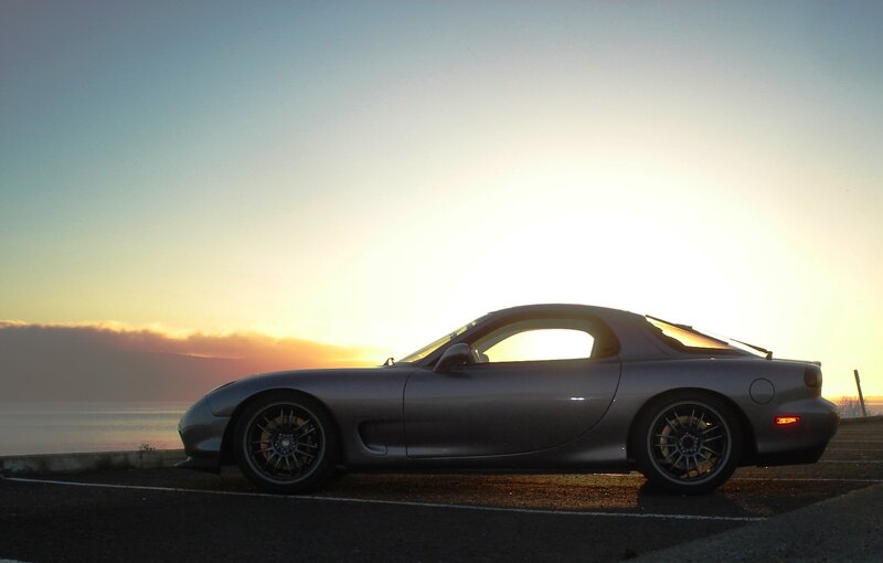 silver sports car at sunset