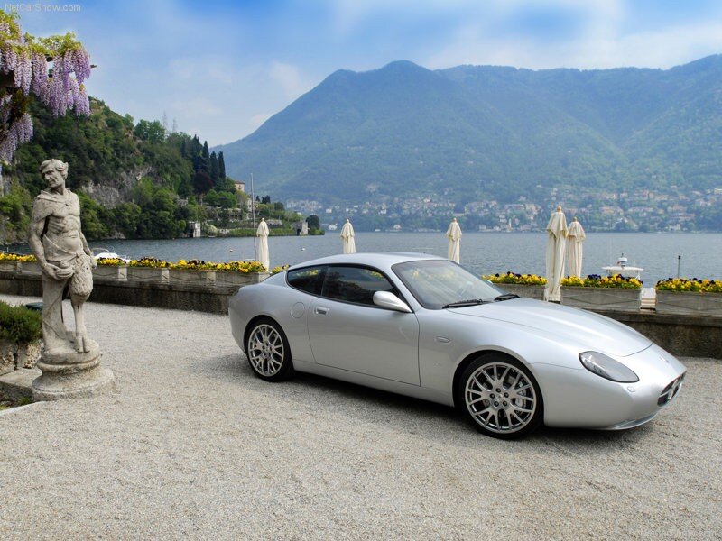 Silver sports car by a lake