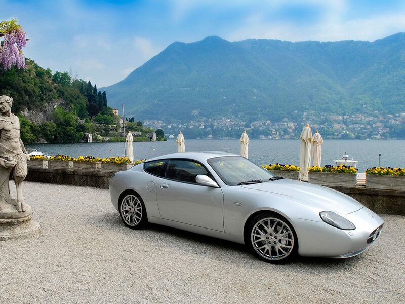 Silver sports car by a lake