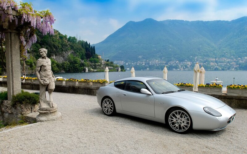Silver sports car by a lake