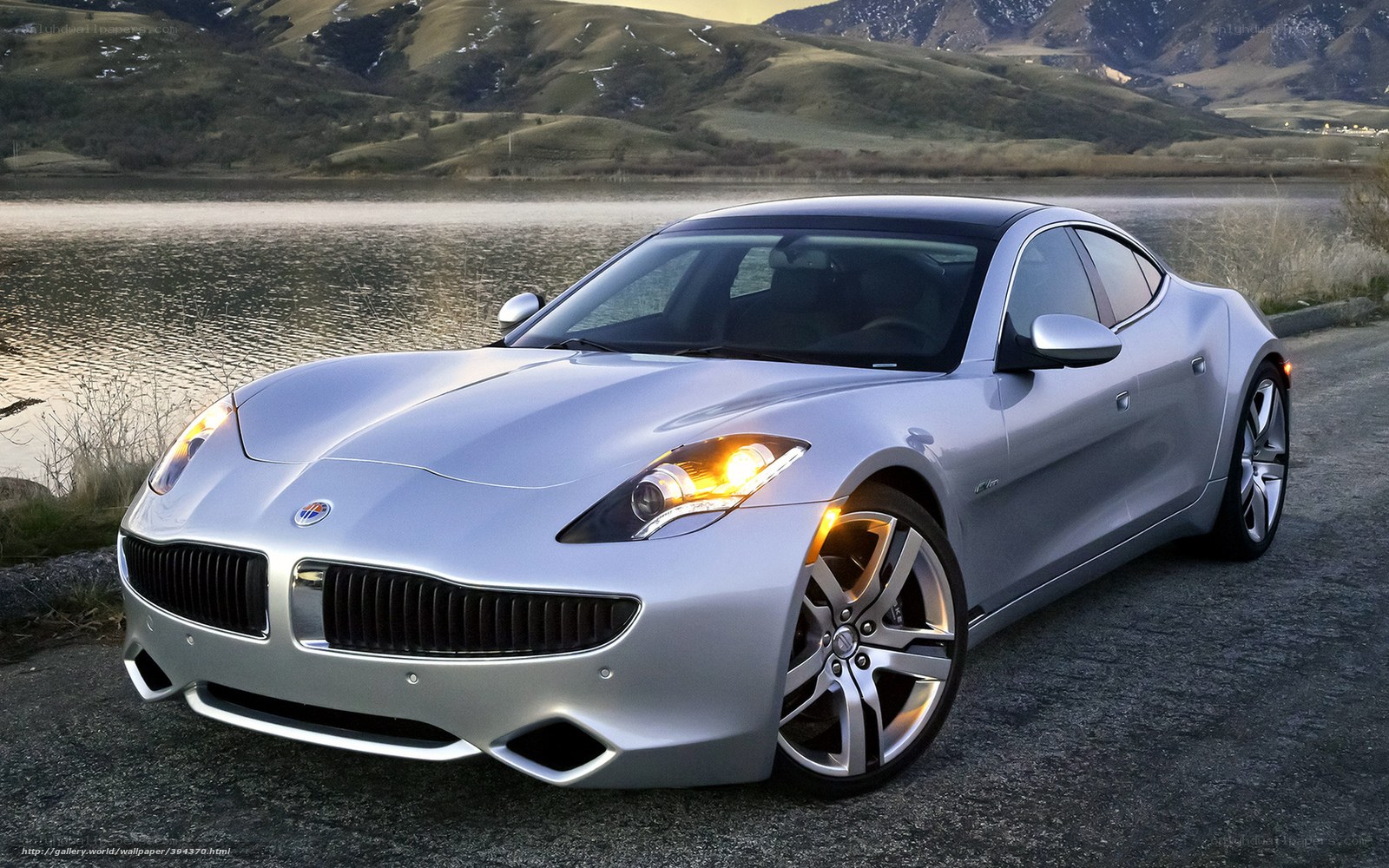Silver sports car by a lake