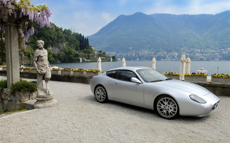Silver sports car by a lakeside