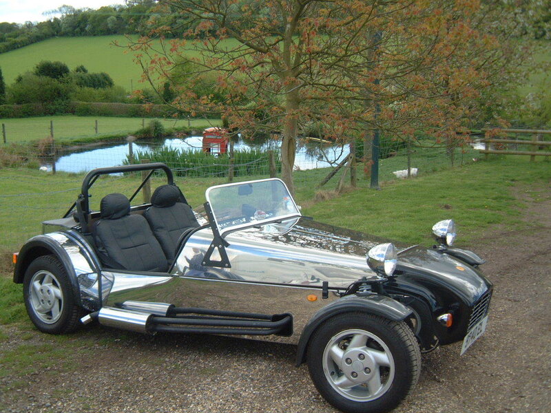 Silver sports car by a pond