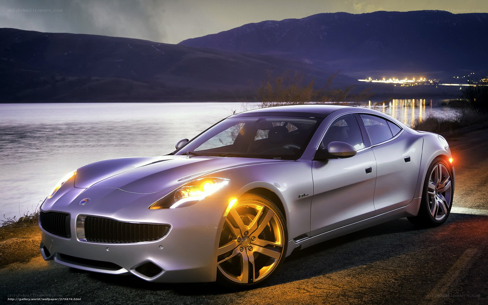 Silver sports car by lake at dusk