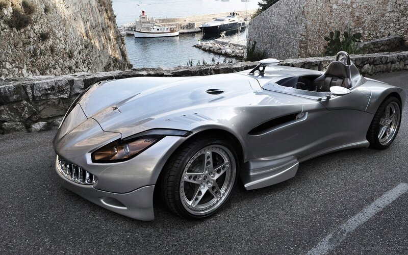 silver sports car by the harbor
