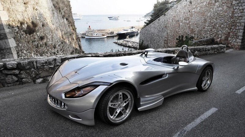 Silver sports car by the harbor