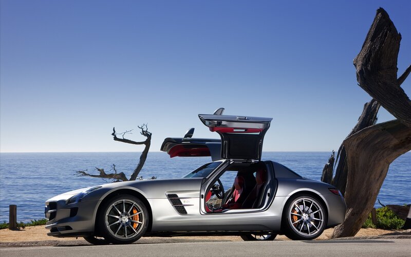 Silver sports car by the ocean