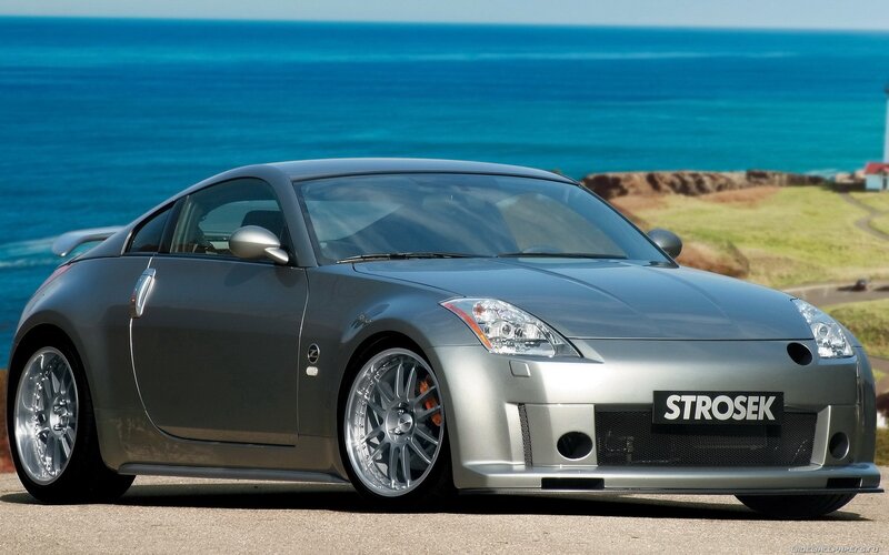 Silver sports car by the ocean
