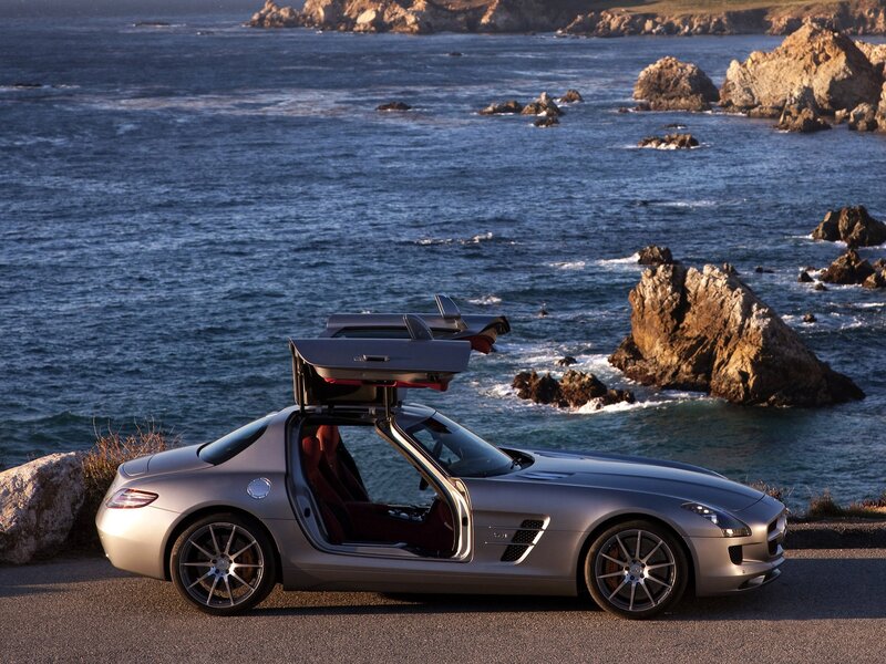 Silver sports car by the ocean