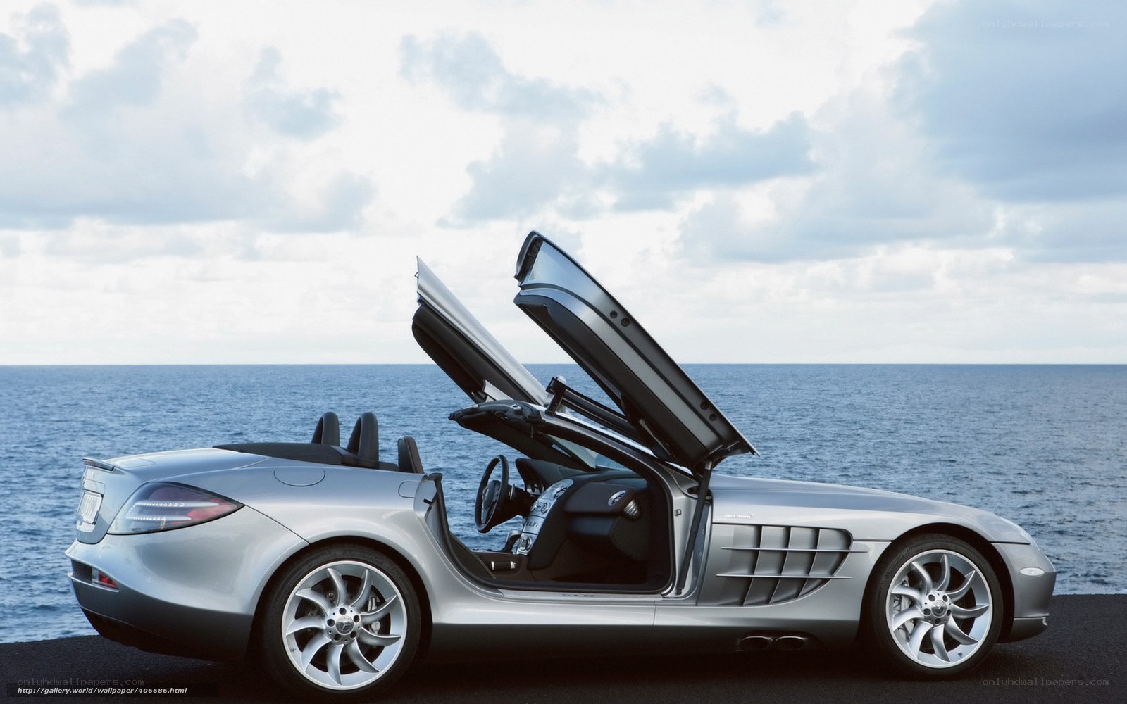 Silver sports car by the sea