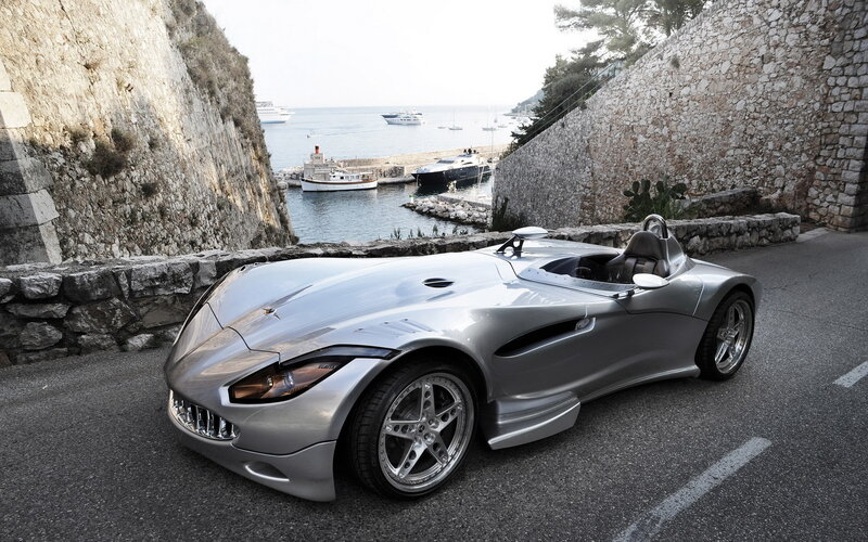 Silver sports car by the sea