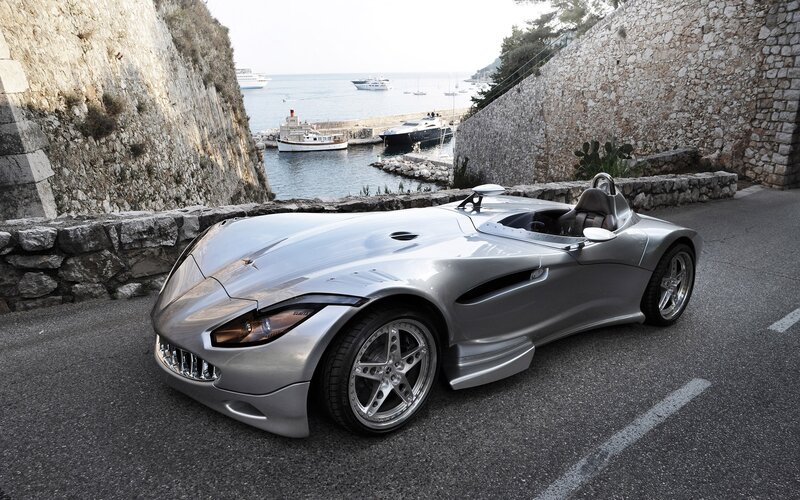 Silver sports car by the sea