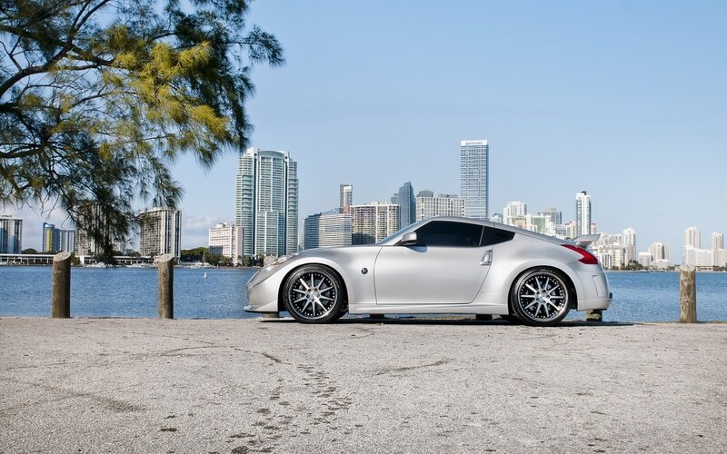 silver sports car by the water