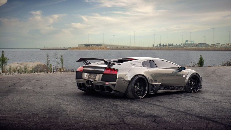 silver sports car by the water