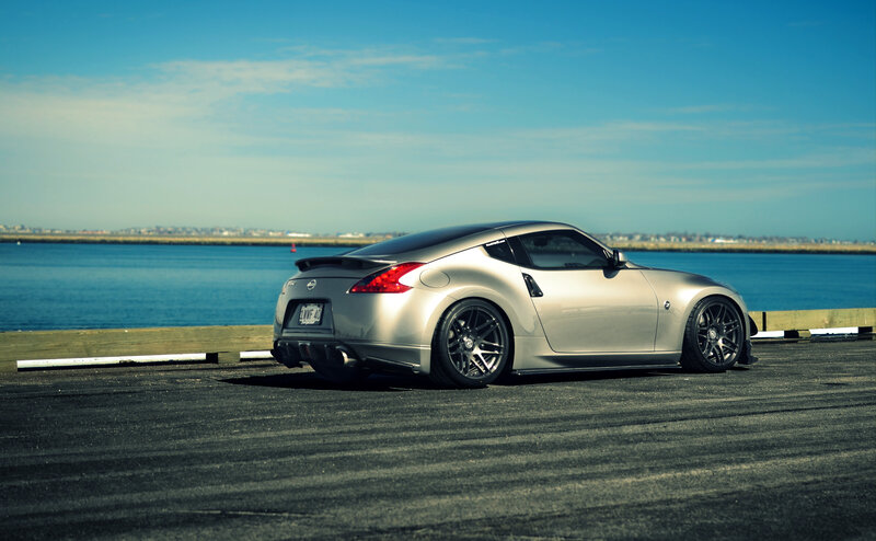 silver sports car by the water