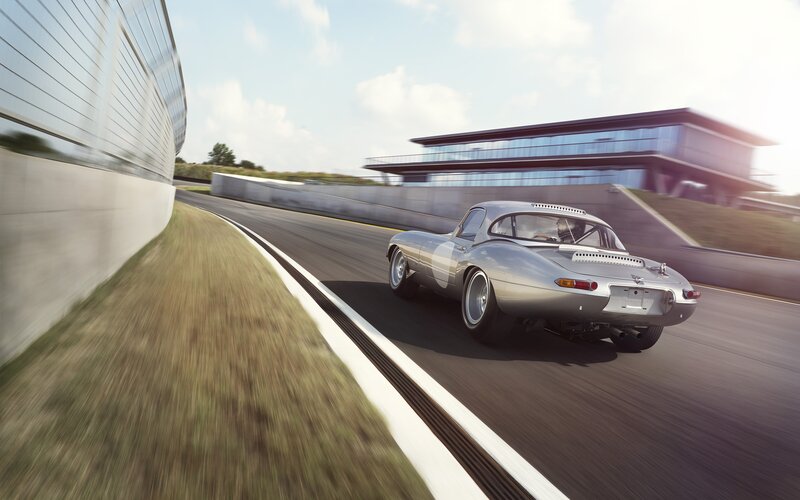 Silver Sports Car — Dynamic, Afternoon, Photograph, Race Track, Building