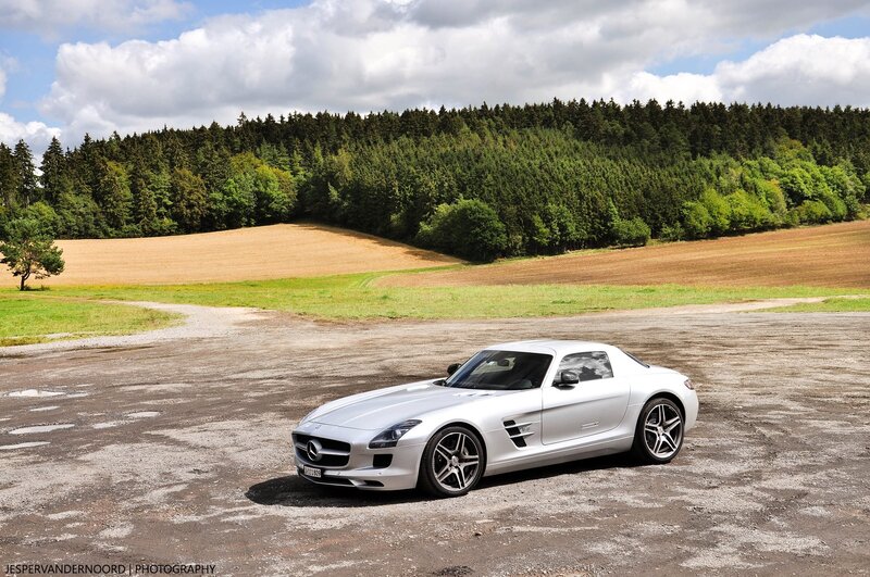 Silver sports car in a field