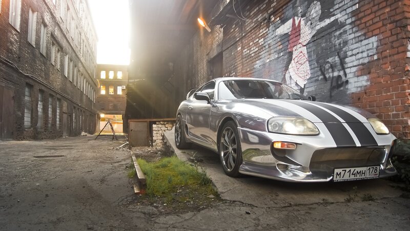 Silver sports car in alley