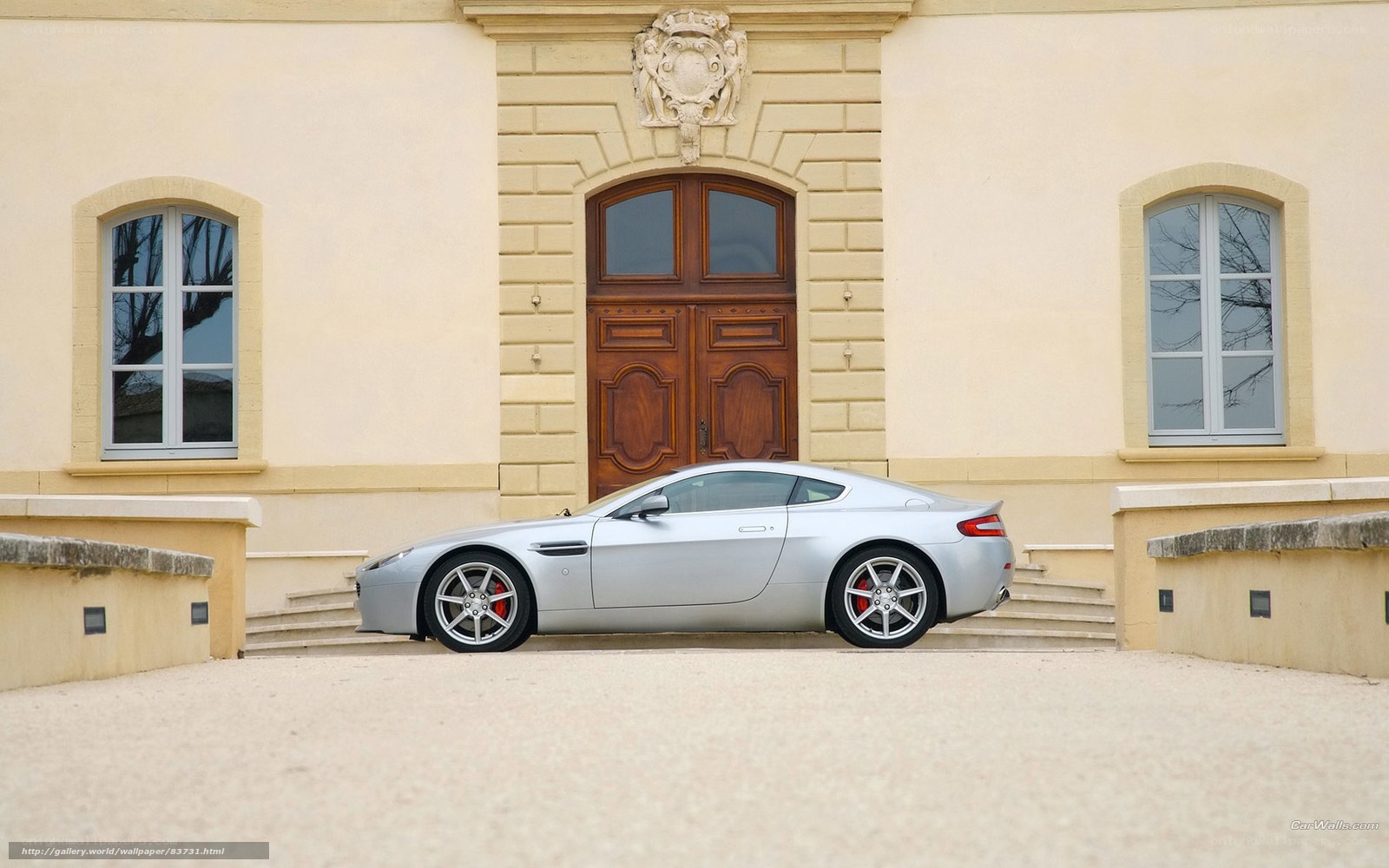Silver sports car in front of mansion