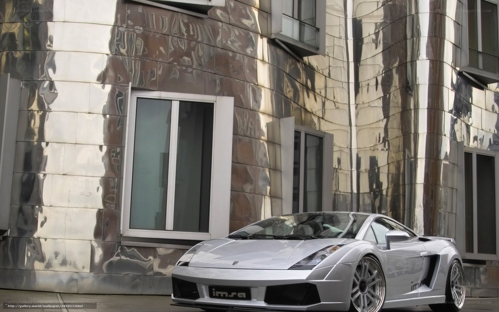 Silver sports car in front of modern building