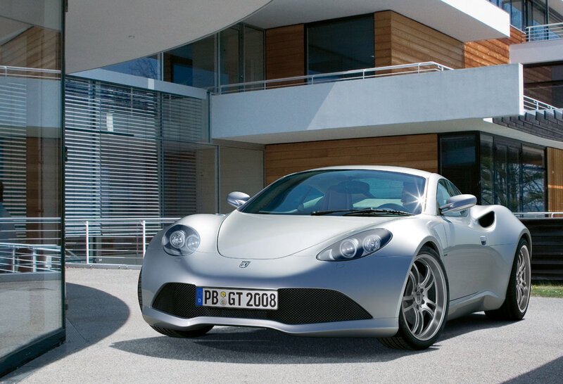 Silver sports car in front of modern house