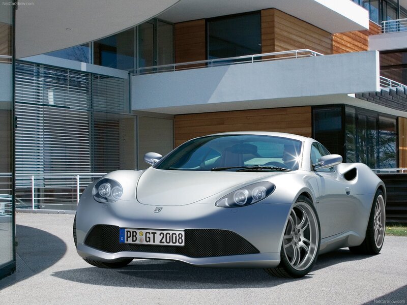 silver sports car in front of modern house