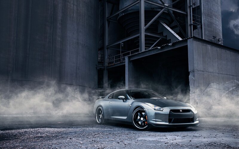 Silver sports car in industrial setting
