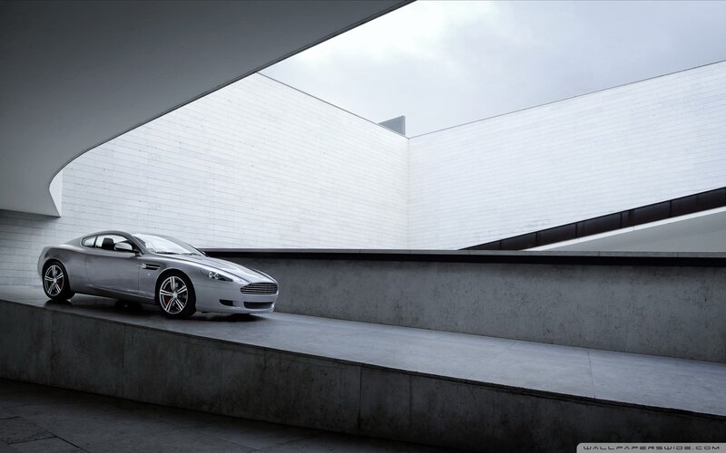 silver sports car in modern architecture